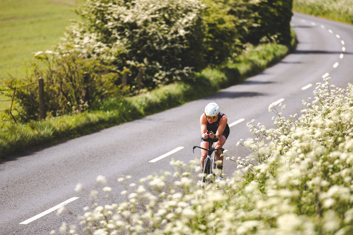 Male triathlete adjusting the sleeve of his tri suit during training, highlighting the importance of comfort and fit in endurance racing.