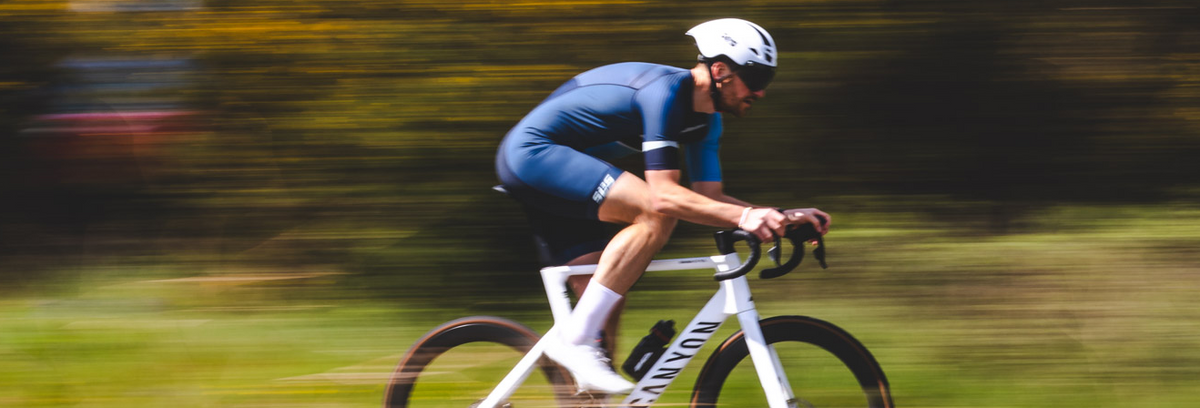  Elite triathlete competing in a race-day compression triathlon suit designed for aerodynamic performance and long-course racing.